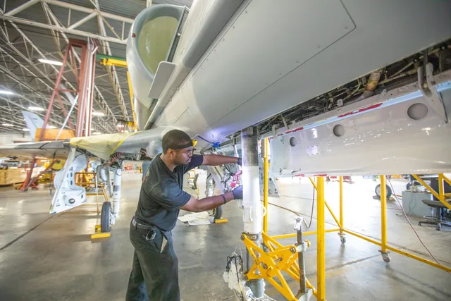 An aviation maintenance technician working on an aircraft in Polk County.